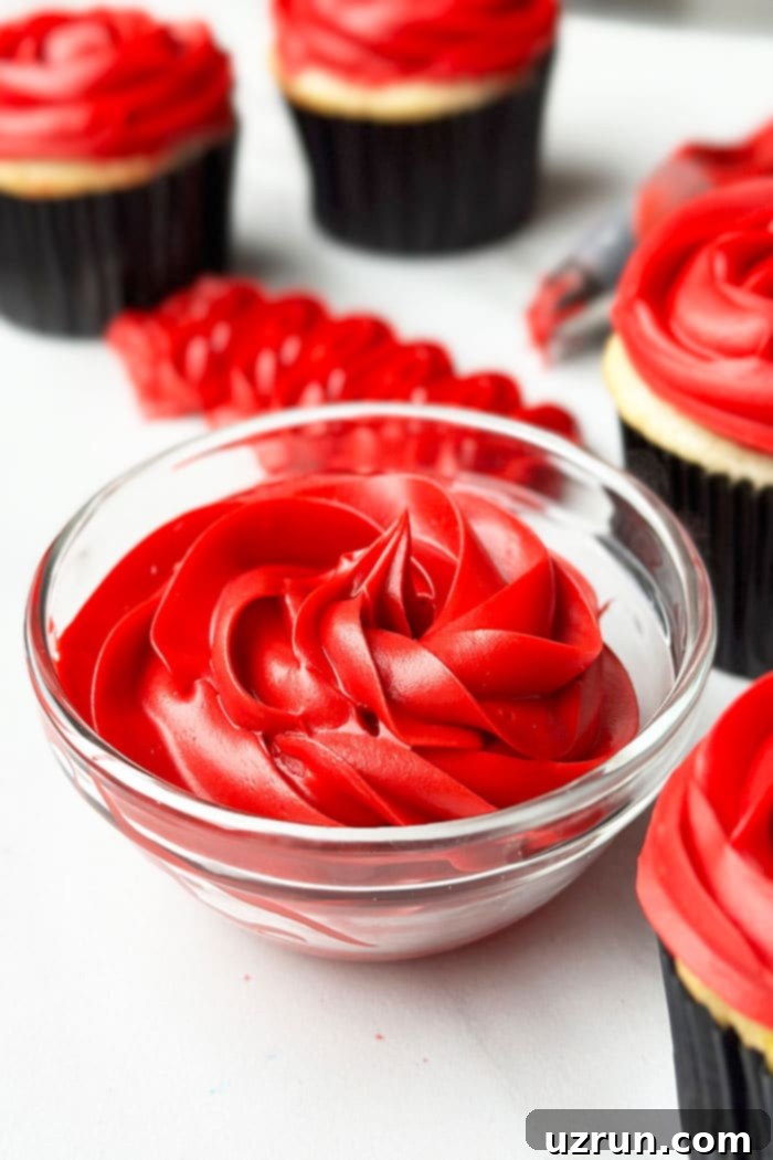 Easy Red Frosting That is Not Pink in Glass Bowl on White Background