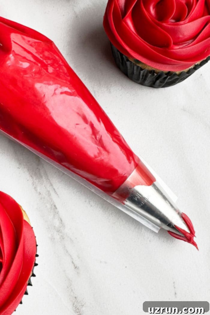 How to Make Red Velvet Frosting 5 Homemade Red Buttercream Icing in Piping Bag on White Background