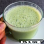 Lucky Green St. Patrick's Day Desserts 14 Easy Homemade Matcha Latte, a vibrant green tea beverage, beautifully served in a clear glass, showing its creamy texture and rich color.