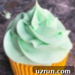 Lucky Green St. Patrick's Day Desserts 10 Close-up of perfectly swirled, vibrant green Easy Mint Frosting, showcasing its smooth and creamy texture, ideal for elegant cake and cupcake decoration.