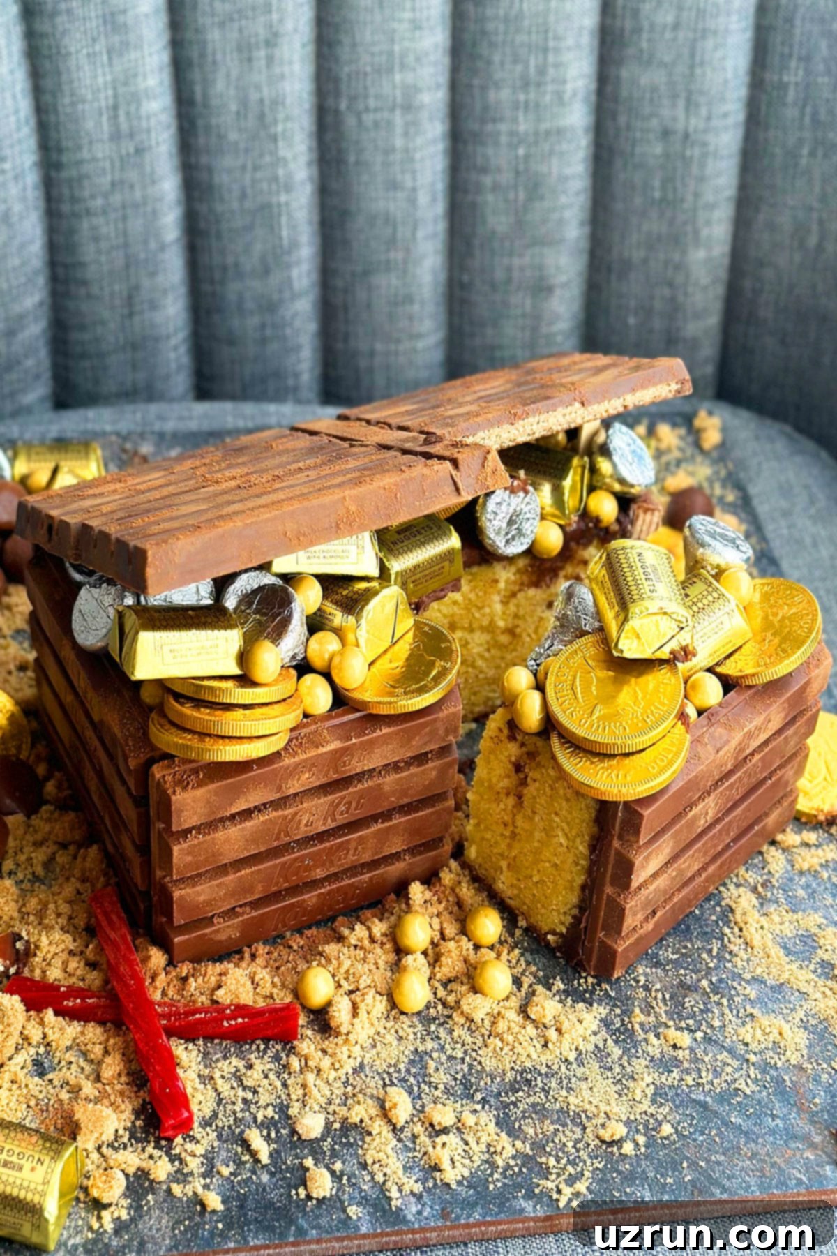 Kit Kat Treasure Chest Cake 7 A beautifully sliced Pirate Treasure Box Cake, revealing its moist interior and overflowing with an assortment of gold and silver candies, tempting all buccaneers.