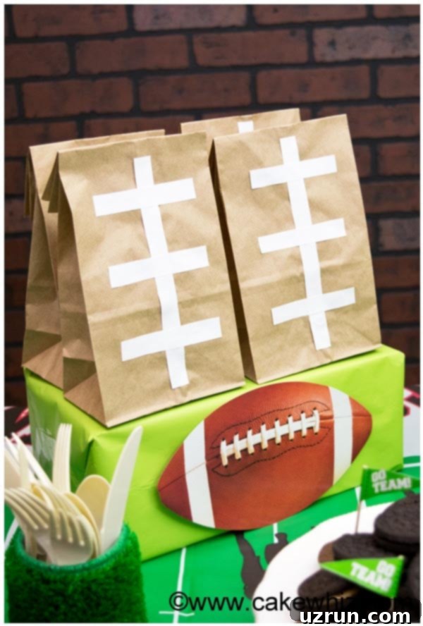 Touchdown Treats: Football Party Cake and Cupcakes 11 Football Party Goodie Bags Displayed on Dessert Table