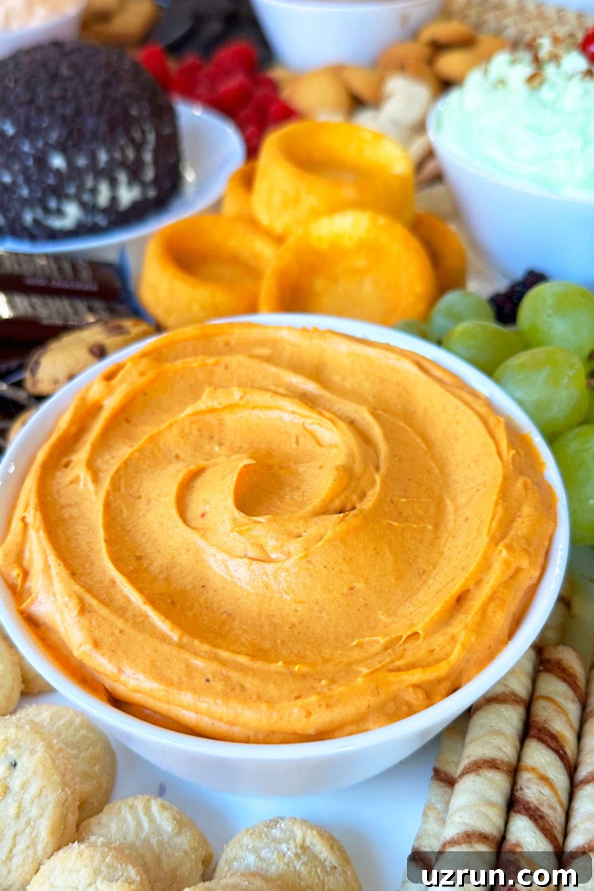 No-Bake Pumpkin Cheesecake Dip 4 Spiced Cheesecake Dip in White Bowl on Tray With Cookies.