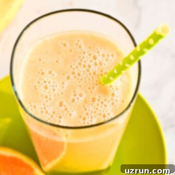 Sunshine Mango Trio Smoothie 4 Easy Mango Smoothie With Bananas and Oranges in Glass Cup.