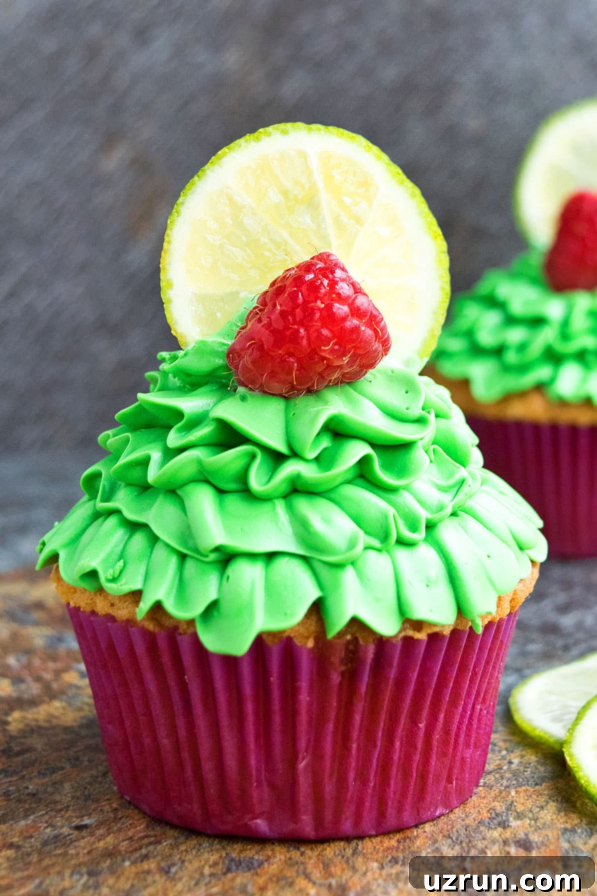 Easy Lemon Raspberry Cupcakes with Cream Cheese Frosting on Rustic Background, showcasing their vibrant color and elegant presentation.