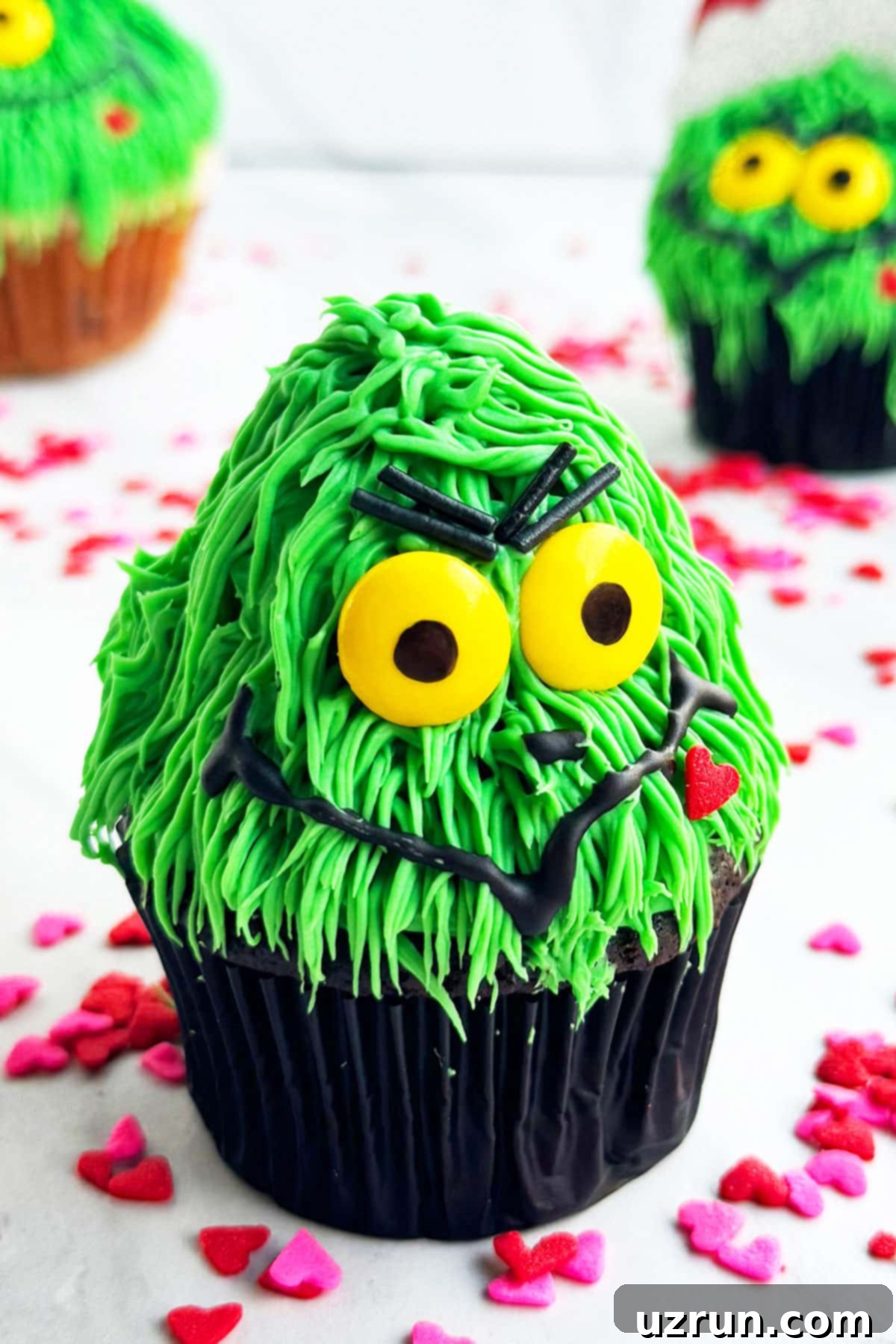 Easy Grinch Cupcakes Decorated With Buttercream Icing on White Marble Background.
