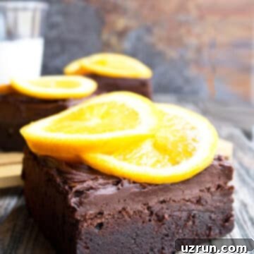 Fudgy Chocolate Orange Brownies 13 Slice of Chocolate Orange Brownies With Chocolate Buttercream Frosting and Fresh Orange Slices.
