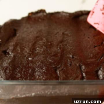 Fudgy Chocolate Orange Brownies 9 Brownie batter being spread in square dish.