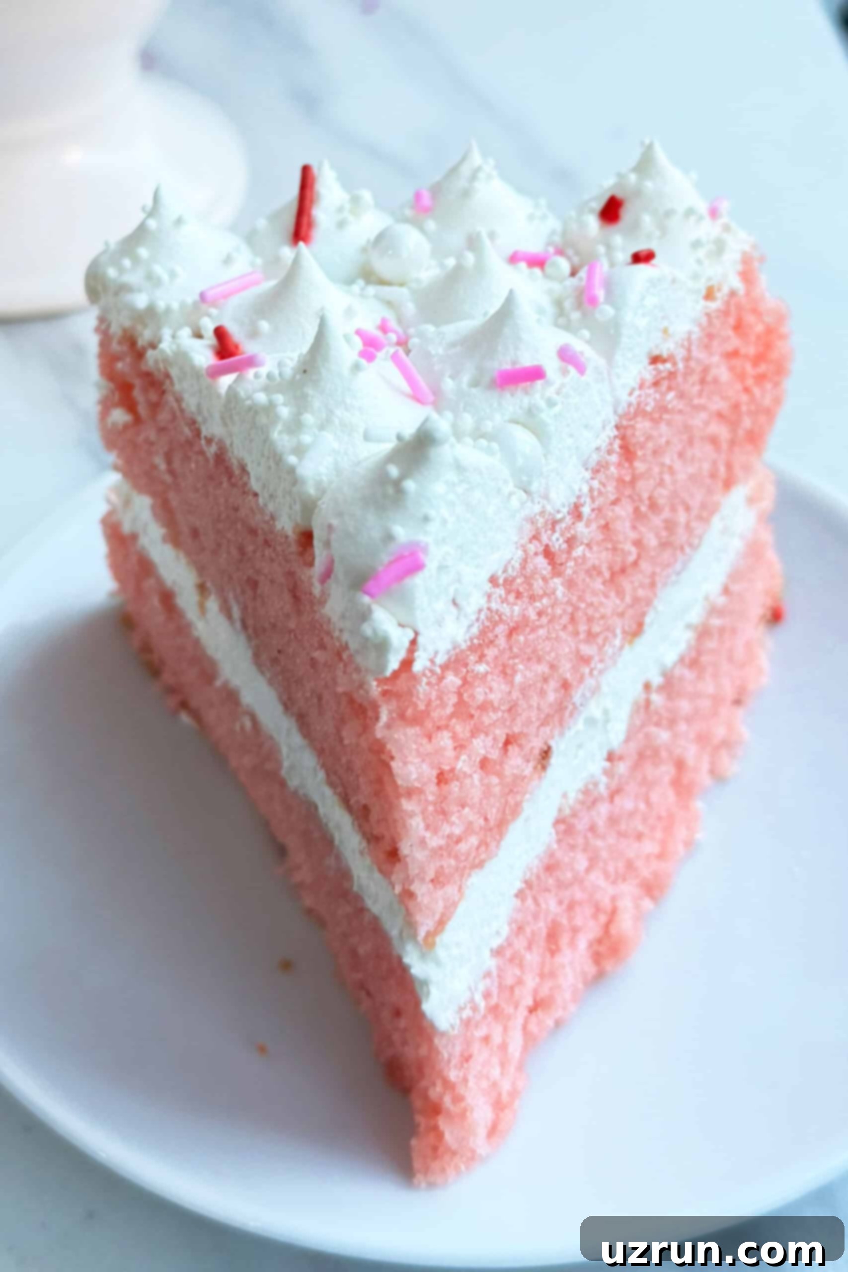Easy Strawberry Pink Champagne Cake 3 Slice of Strawberry Champagne Layer Cake On White Dish.