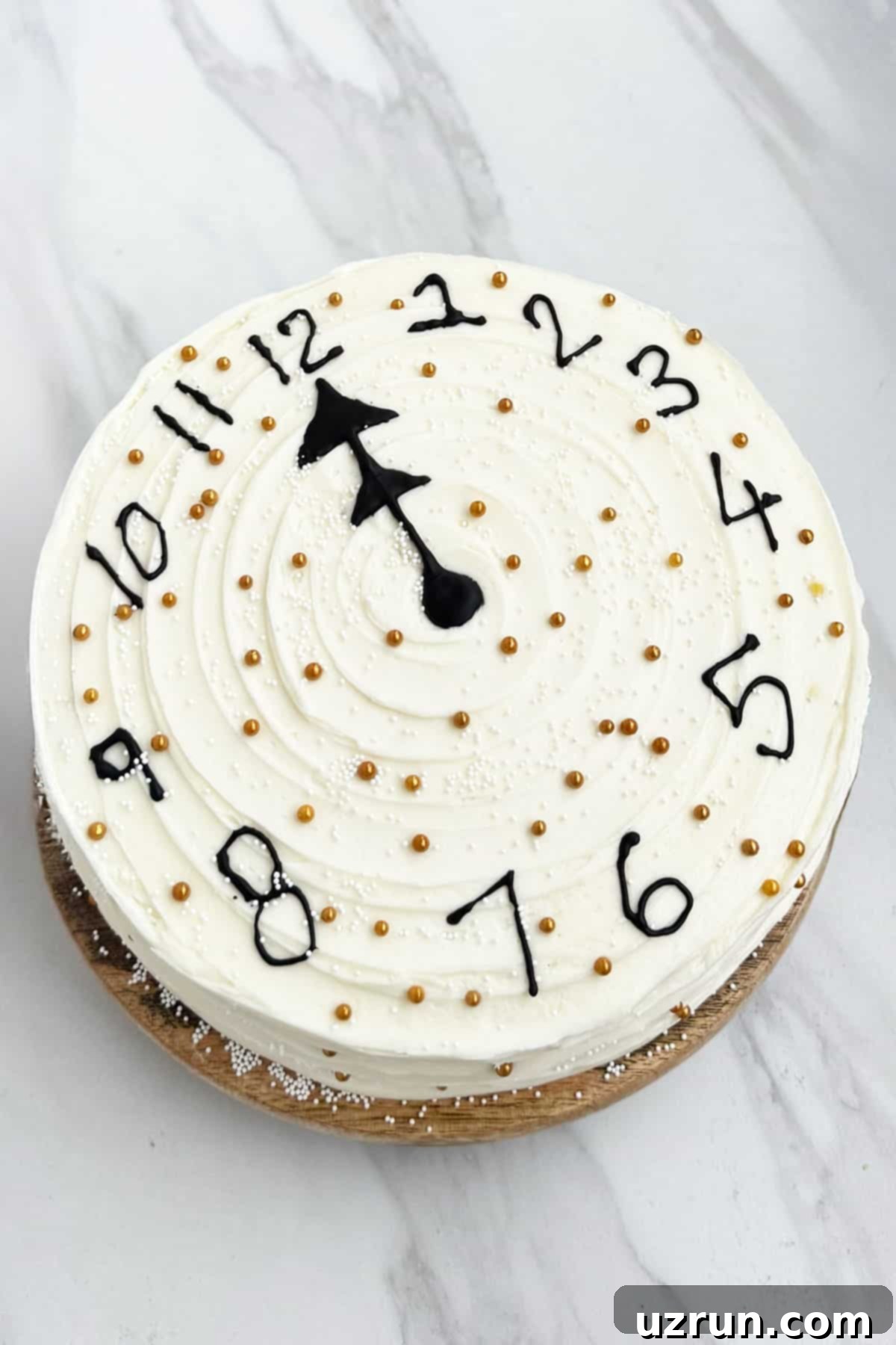 Easy New Year Clock Cake 5 Decorated White and Black Buttercream Cake on Marble Background.