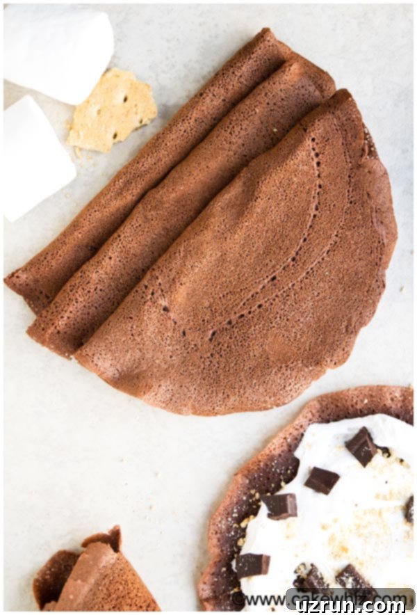 Effortless Blender Chocolate Crepes 4 Overhead Shot of Folded Best Cocoa Crepes on White Background