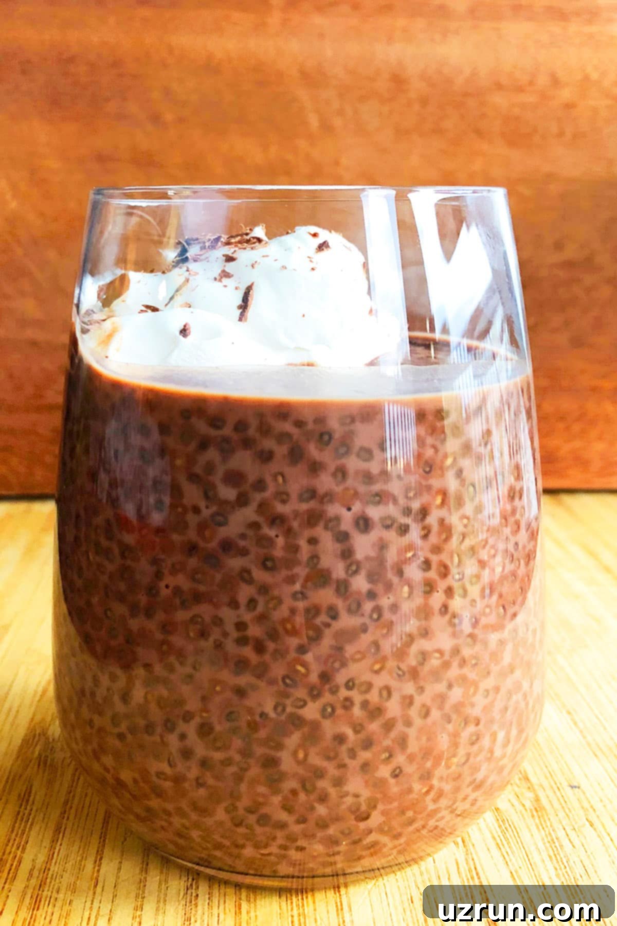 Easy Chocolate Chia Seed Pudding With Whipped Cream in Glass Cup.