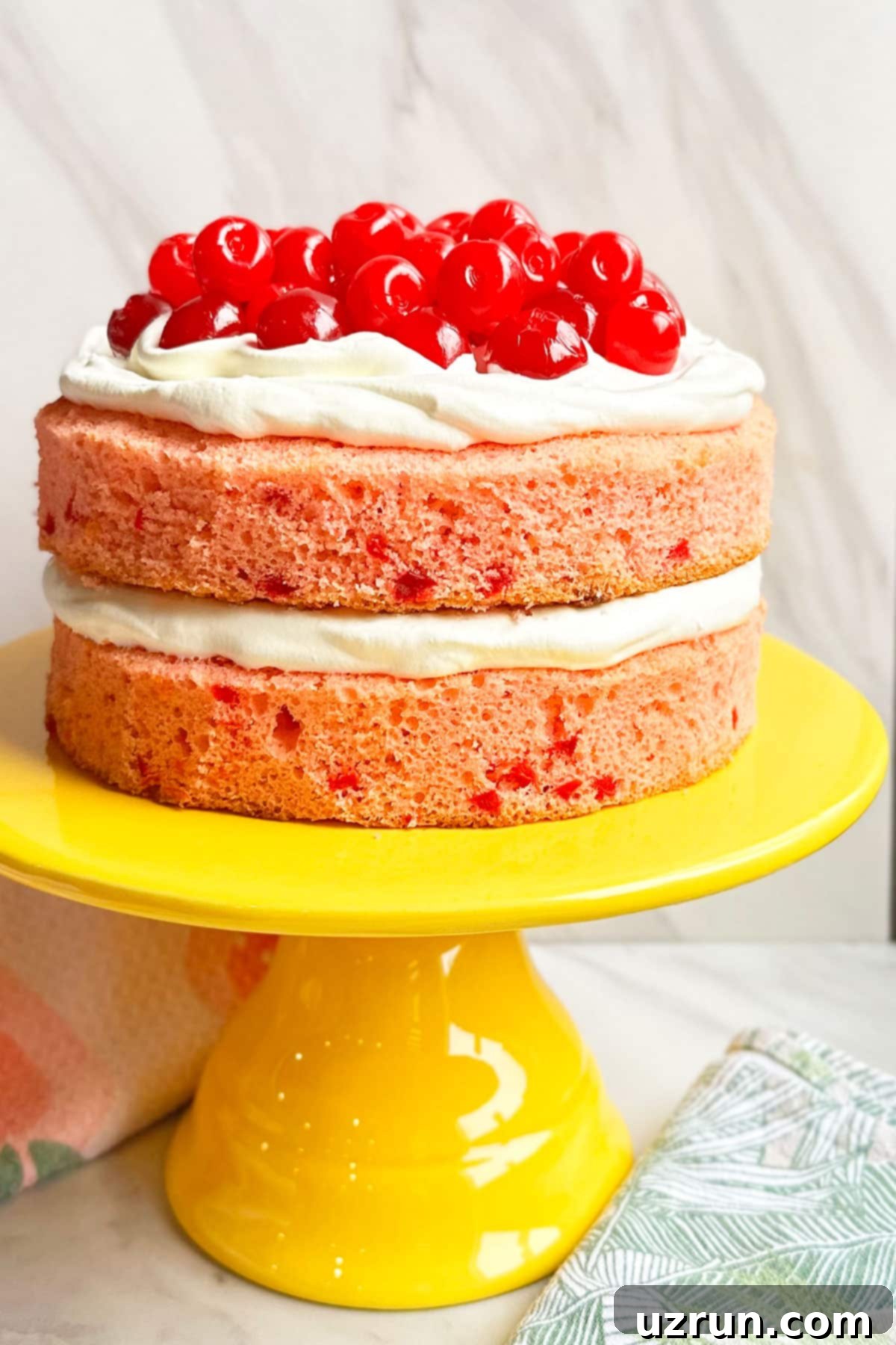 Easy Maraschino Cherry Cake With Cake Mix on Yellow Cake Stand And Marble Background