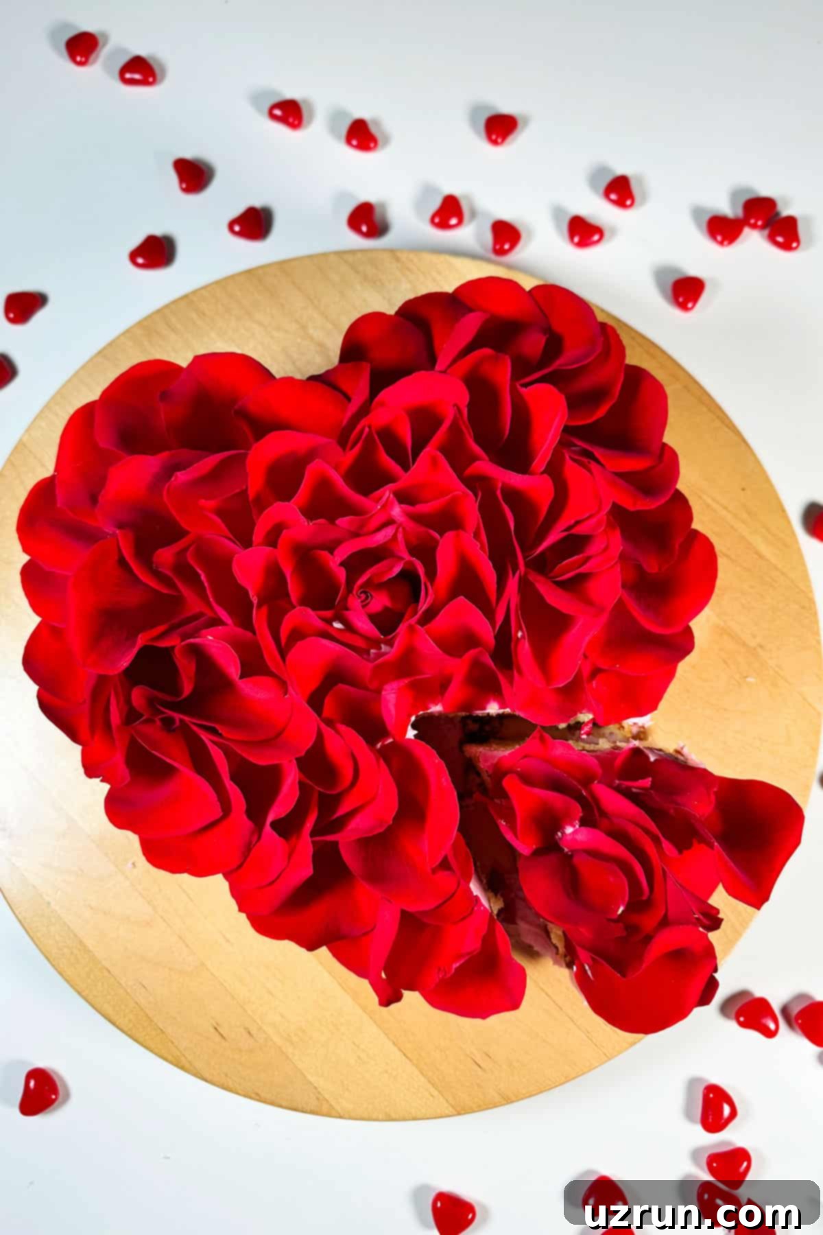 Easy Red Rose Cake with Fresh Flower Petals on Wood Cake Stand. A beautifully decorated heart-shaped red rose cake with vibrant fresh petals, perfect for a romantic celebration.