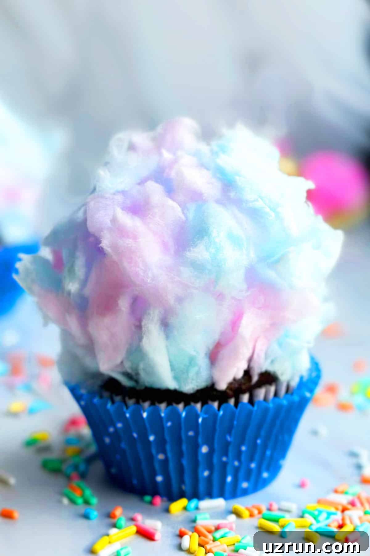 Easy Cotton Candy Cupcakes 2 Easy Cotton Candy Cupcakes in Polka Dot Blue Liner on Marble Background.