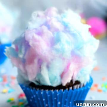 Easy Cotton Candy Cupcakes 5 Easy Cotton Candy Cupcakes in Polka Dot Blue Liner on a Marble Background.