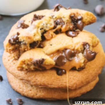 Salted Caramel Chocolate Chip Cookies 11 Stack of baked cookies with one broken in half.
