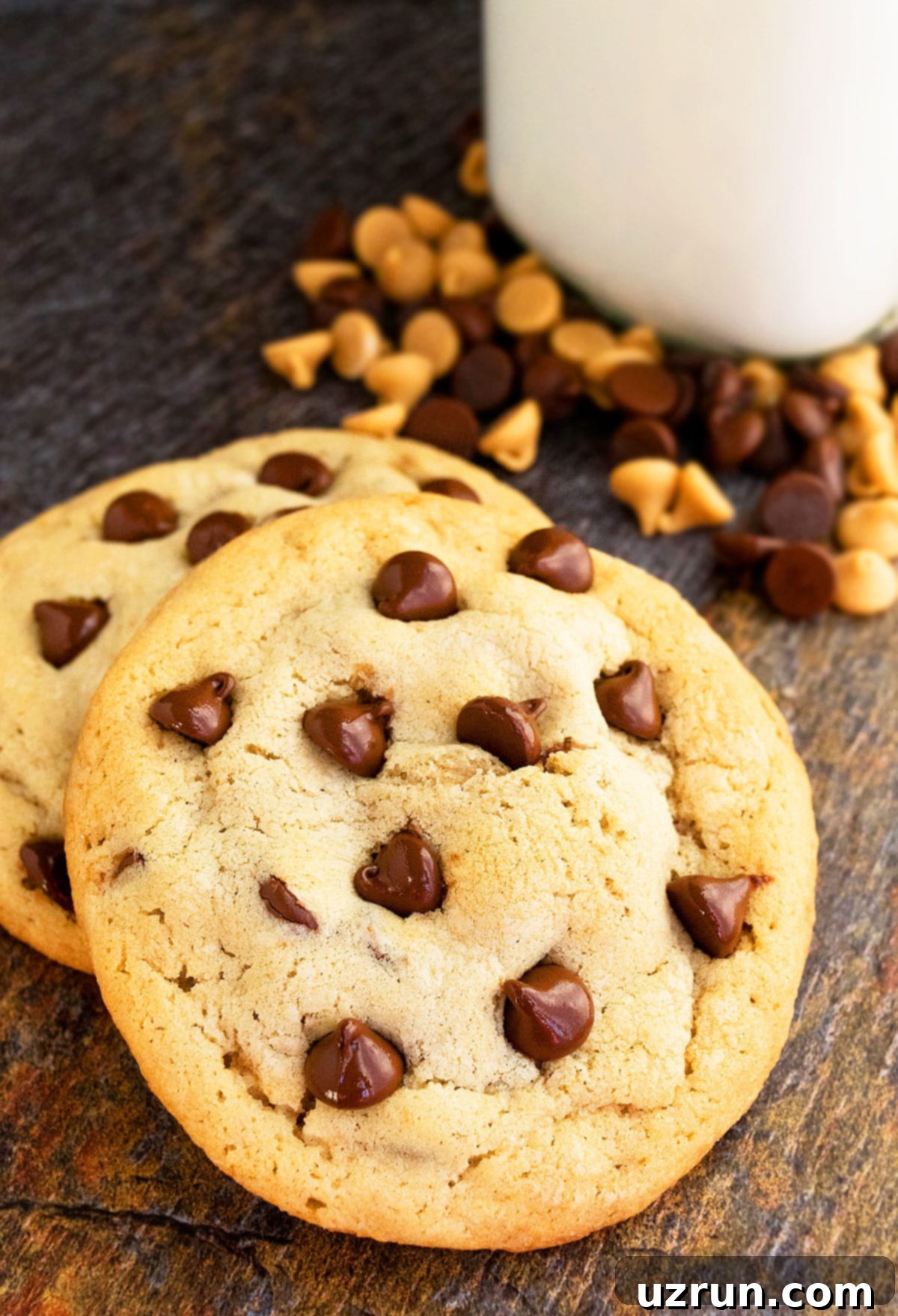Salted Caramel Chocolate Chip Cookies 3 Two Stuffed Cookies on Rustic Brown Background With Coffee Mug in the Background.