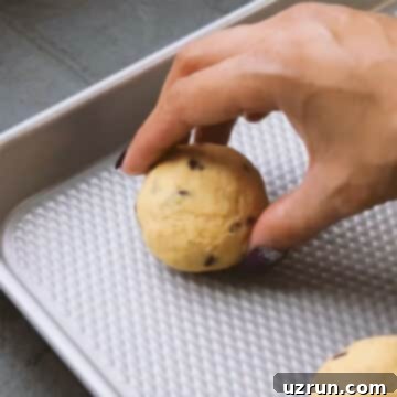 Salted Caramel Chocolate Chip Cookies 10 Cookie dough ball being placed on a baking tray.