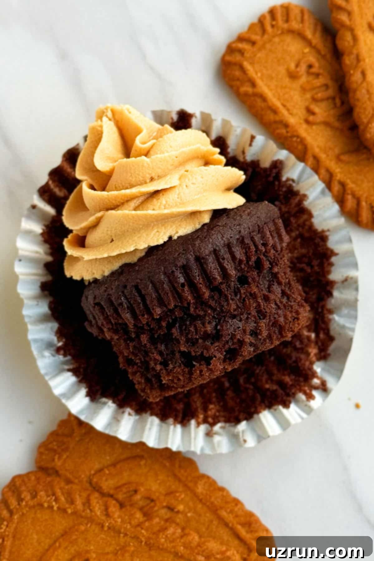 Easy Cake Mix Biscoff Cupcakes 3 Cookie Butter Cupcakes With Cookie Butter Frosting- Liner Removed. A close-up showing the moist interior and filling.