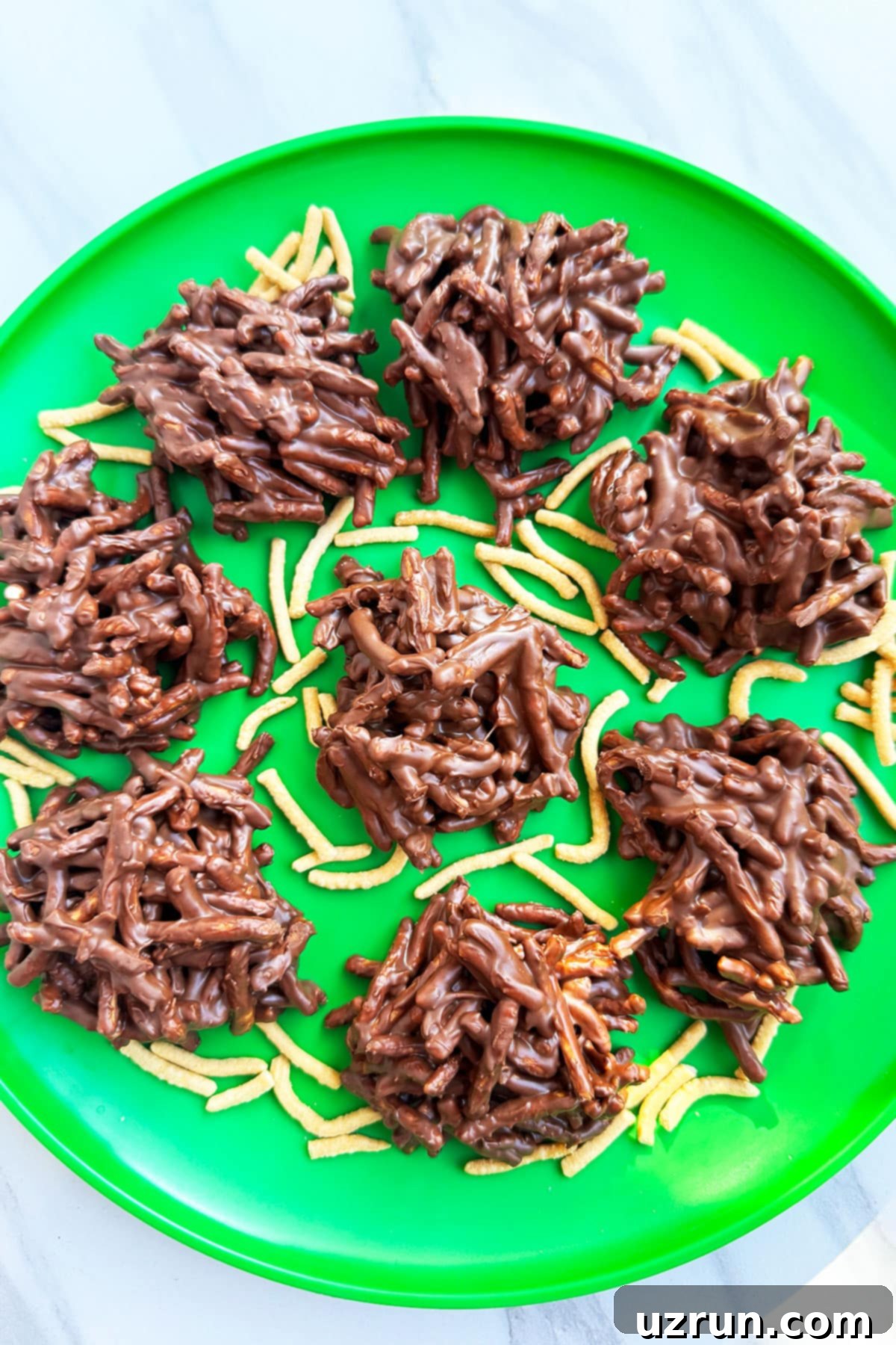 Easy No Bake Haystack Cookies With Chocolate Chips And Butterscotch on Green Dish.