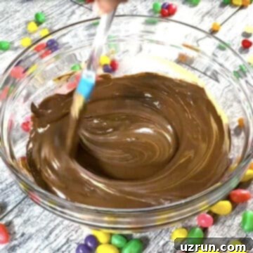 Easy No-Bake Chocolate Haystacks 5 Melted chocolate, butterscotch and peanut butter mixture in glass bowl.