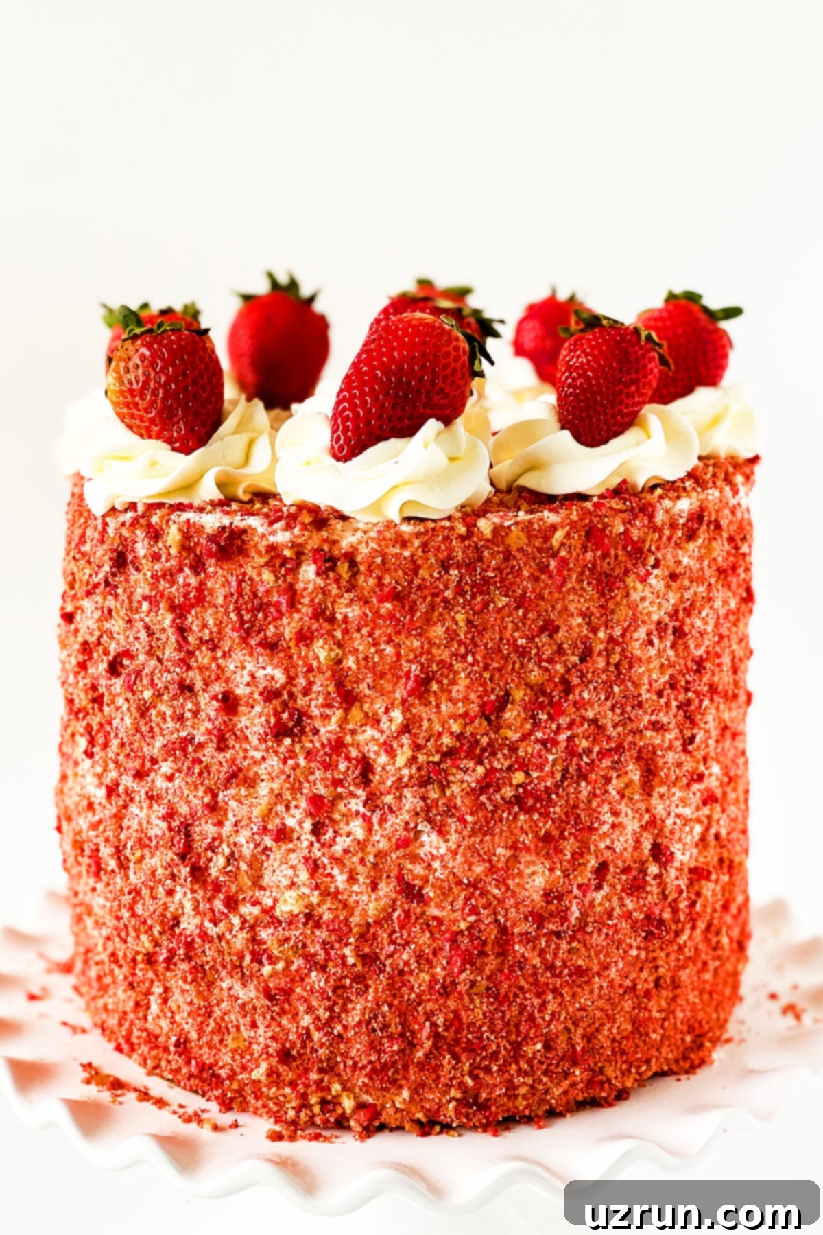 Layered Strawberry Crunch Cake With Cake Mix Box Covered in Buttercream Frosting and Crunchy Topping and Fresh Strawberries. 