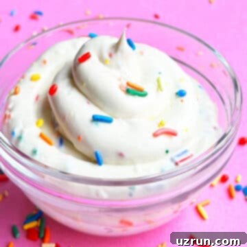 Funfetti Cake Batter Dip 5 Glass Bowl of Funfetti Cake Batter Dip Topped With Colorful Sprinkles on Pink Background.