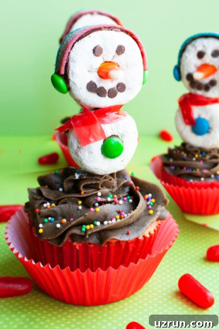 Easy Snowman Cupcakes With Donut Toppers on Green Background