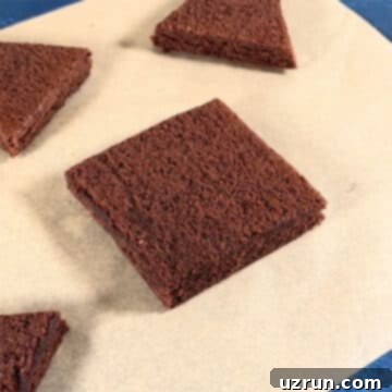 Christmas Tree Brownie Bites 4 Square slice of brownie on brown parchment paper.