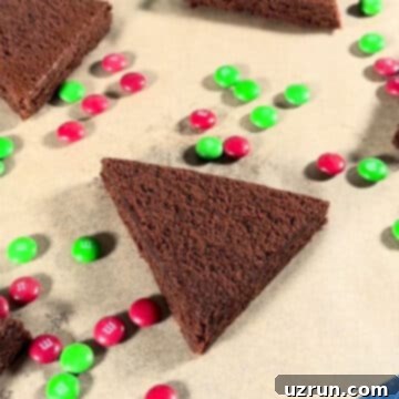 Christmas Tree Brownie Bites 5 Triangle slice of brownie on brown parchment paper.