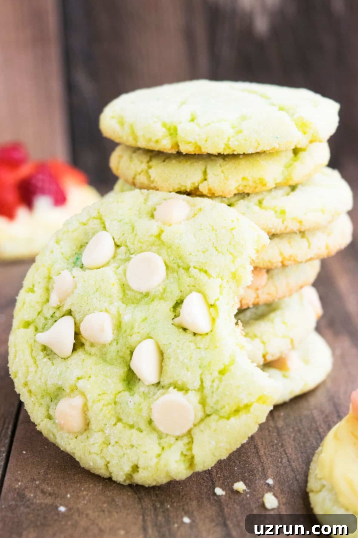 Zesty Key Lime Crinkle Cookies 4 Partially Eaten Cookie on Wood Background.