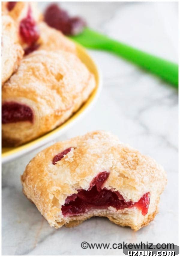 Easy Strawberry Strudel with Puff Pastry 4 Partially Eaten Strudel on White Background