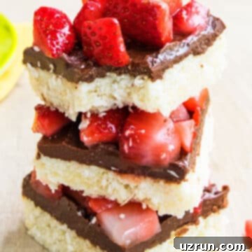 Chocolate Coconut Macaroon Bars 12 Stack of Easy Chocolate Coconut Bars on Wood Background with fresh strawberries.