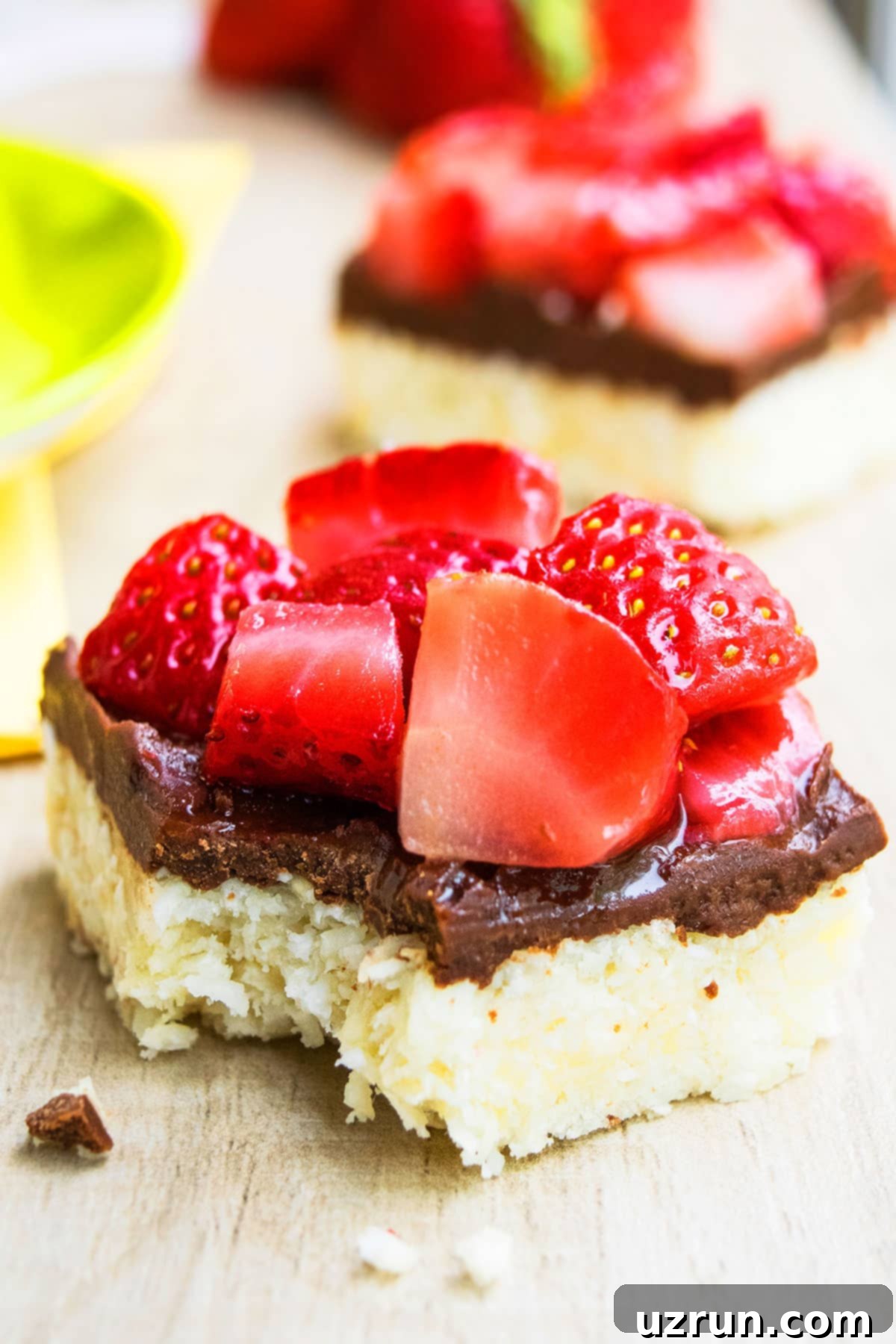 Chocolate Coconut Macaroon Bars 9 Partially Eaten Macaroon Bars With Chocolate and Strawberries, showing the delicious layers.
