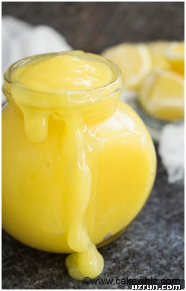 Easy Homemade Lemon Curd in a Glass Jar on a Rustic Gray Background