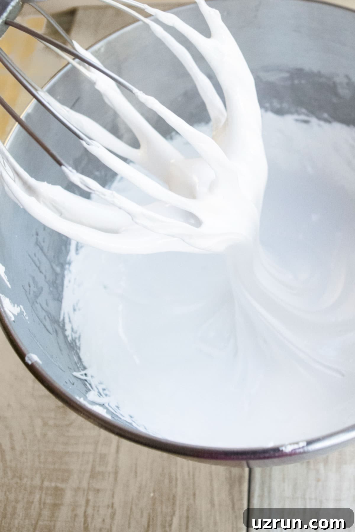 Fluffy Meringue in Minutes 5 Fluffy White Frosting Without Butter on Whisk Over Bowl.