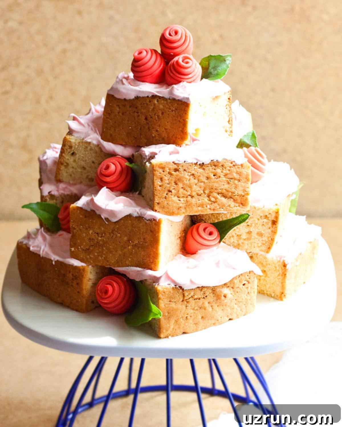 Easy Cake Decorating Ideas for Beginners 22 A unique cake tower made by artfully stacking individual cake slices, decorated with fondant roses.