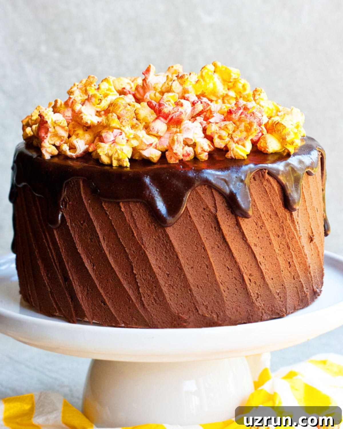Easy Cake Decorating Ideas for Beginners 25 A unique cake decorated with popcorn and chocolate ganache drips, creating a fun, textured look.