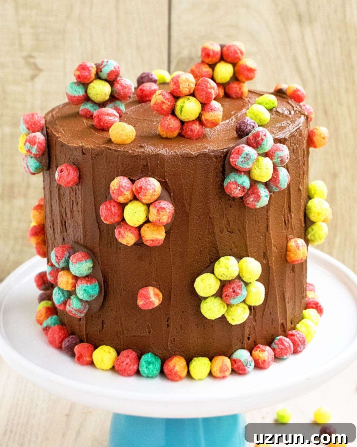 Easy Cake Decorating Ideas for Beginners 26 A vibrant cake decorated with colorful Trix cereal arranged in flower patterns, adding a playful touch.