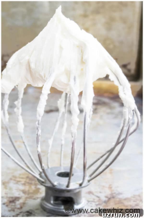 Easy Cream Cheese Icing on Whisk for Piping and Cake Decorating 
