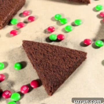 Christmas Santa Hat Brownie Bites 4 Triangle brownie slice on brown parchment paper, showing the diagonal cut.