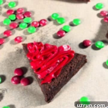 Christmas Santa Hat Brownie Bites 6 Red frosting swirls fully covering the triangle brownie, leaving space at the bottom and tip.