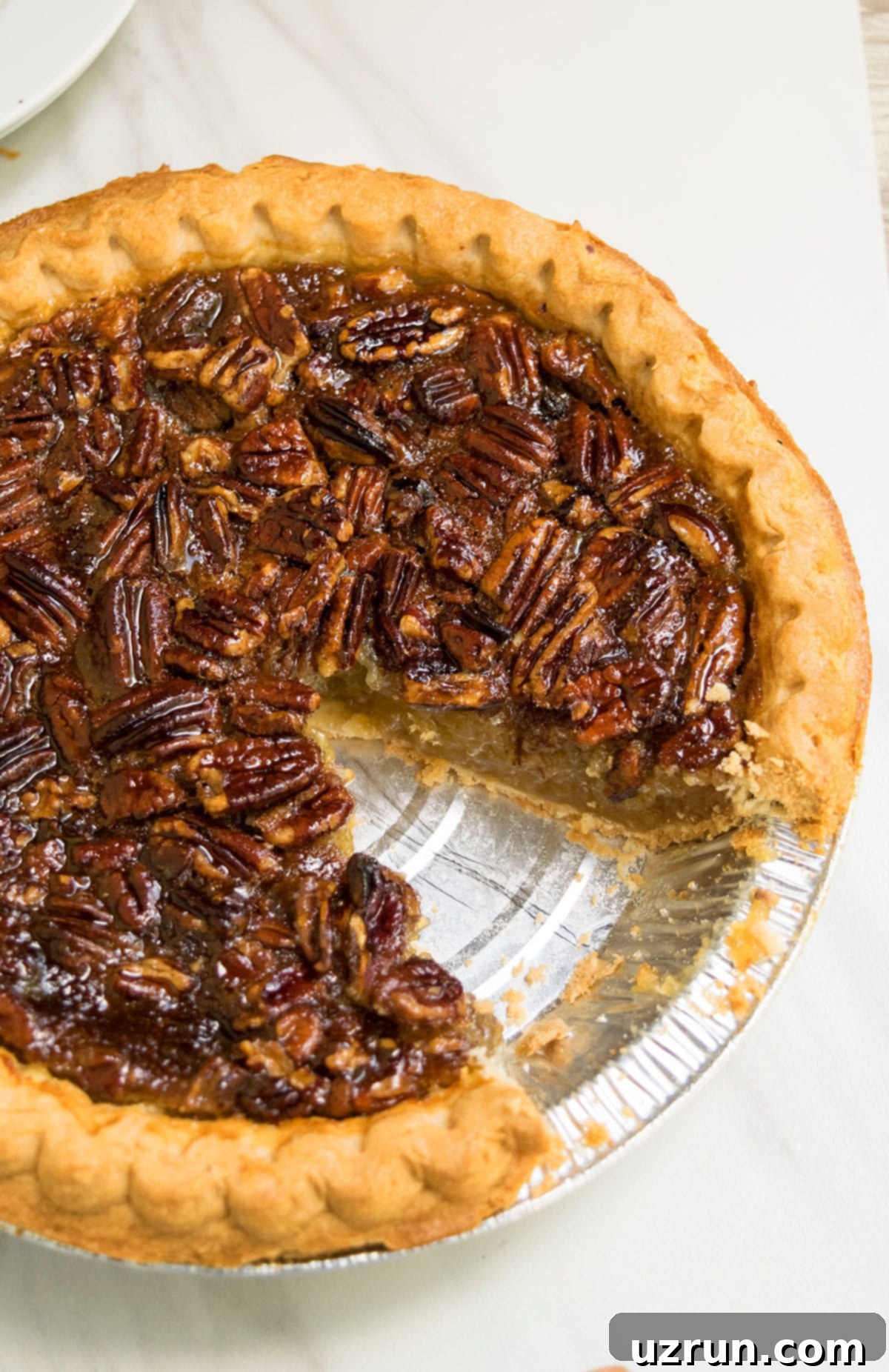 Perfectly Easy Pecan Pie 3 Easy Pecan Pie With One Slice Removed on White Background