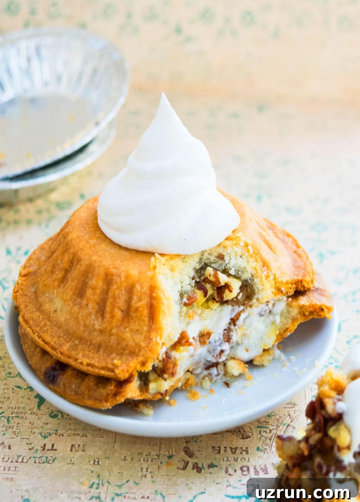 Perfectly Easy Pecan Pie 5 Mini Pie Sandwich With Whipped Cream on White Plate