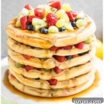 Waffle Cake Made Easy 6 Easy Waffle Cake With Peanut Butter, Maple Syrup and Fresh Fruits on White Cake Stand.