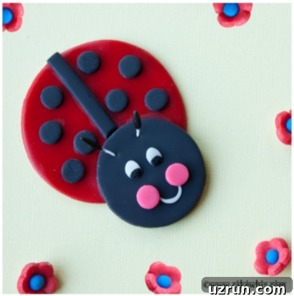 Crafting Unique English Titles 3 Close-up of a homemade fondant ladybug cupcake topper with details like spots, eyes, and antennae on a yellow background.