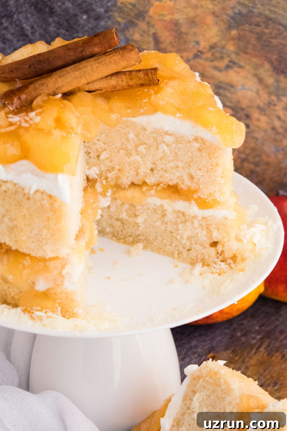 Apple Pie Cake With Pie Filling 3 Closeup Shot of Cake With One Slice Removed on White Cake Stand
