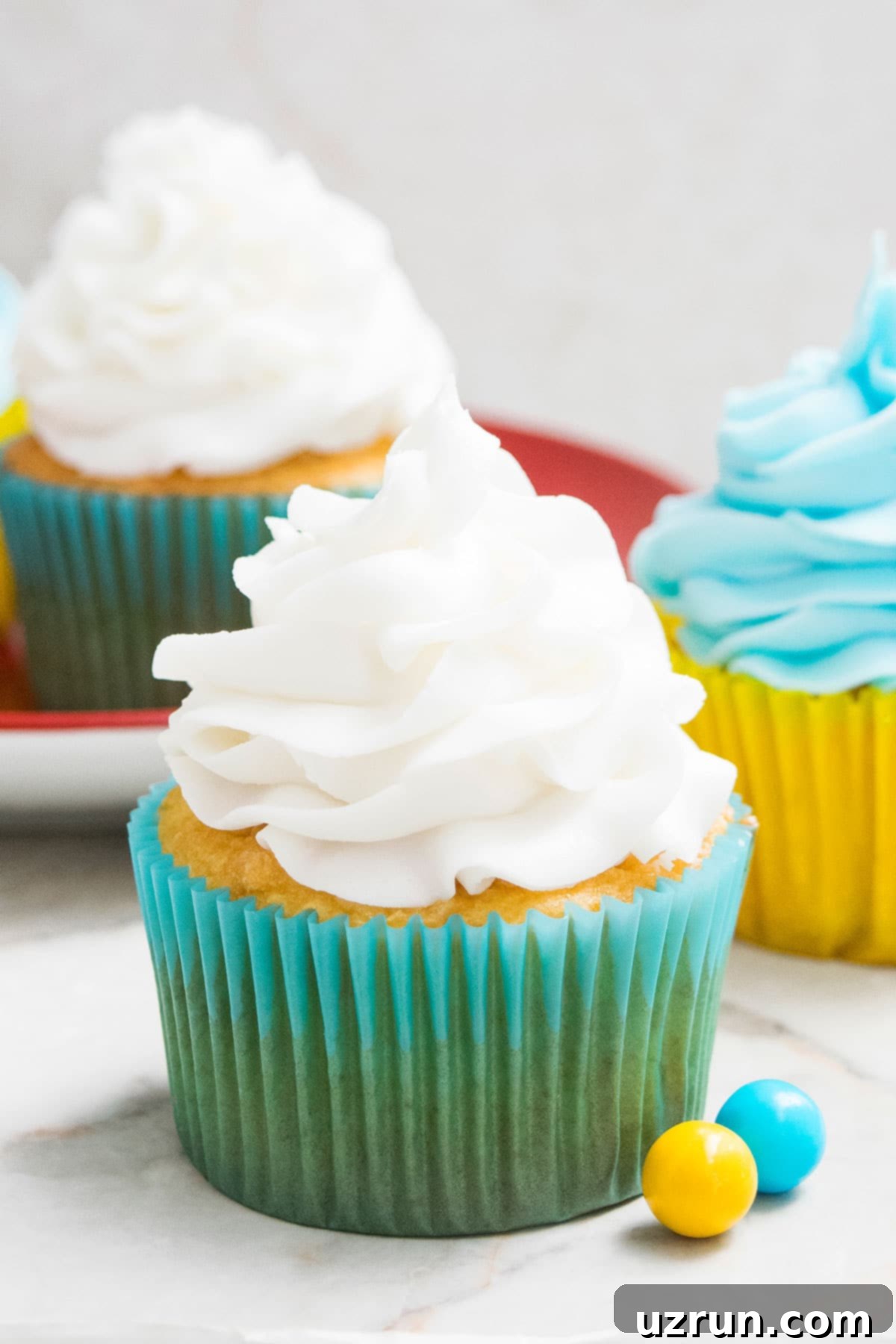 Easy White Chocolate Buttercream Frosting Swirled on Top of Cupcake.