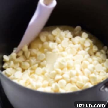 Easy Two-Ingredient White Chocolate Buttercream 4 White chocolate chips and butter in black nonstick saucepan.